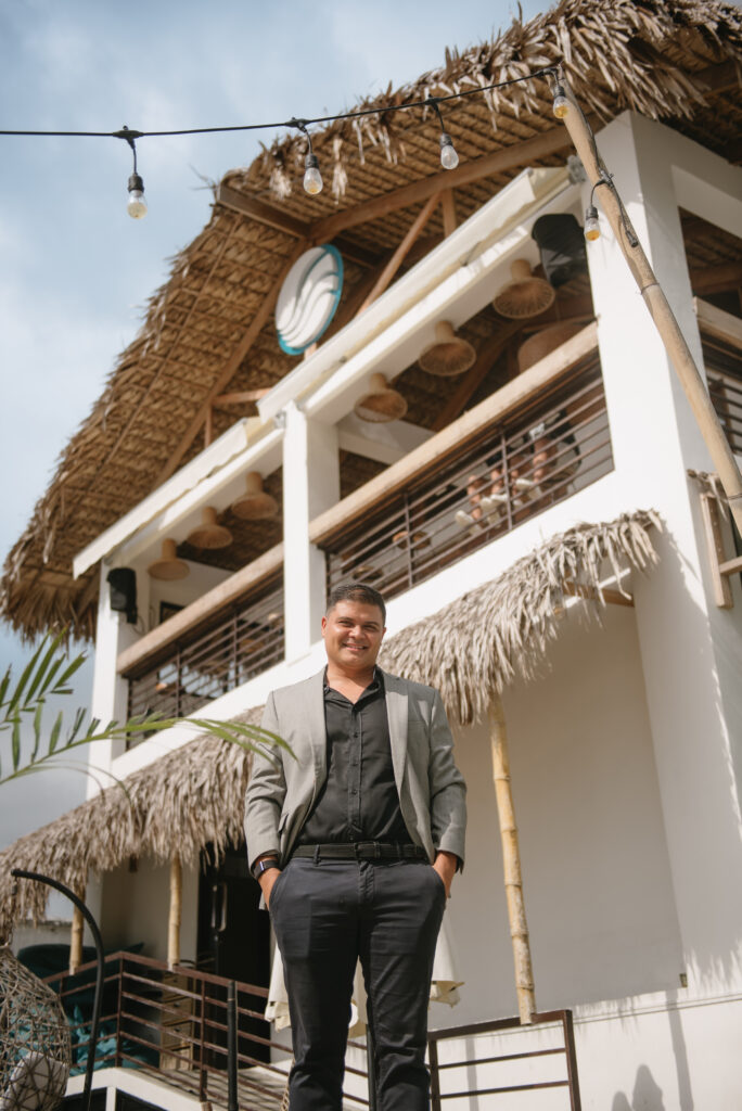 Mark Oliver Riman standing in front of Taaw Beach Club